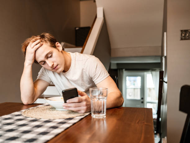 istock Young man gaming at home 1287921483