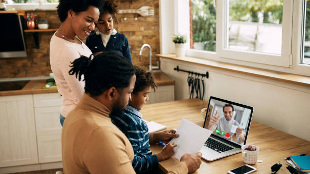 Black parents and their kids communicating with their insurance agent over laptop while being at home. Focus is on woman. Black parents and their kids communicating with their insurance agent over laptop while being at home. Focus is on woman. financial advisor virtual stock pictures, royalty-free photos & images
