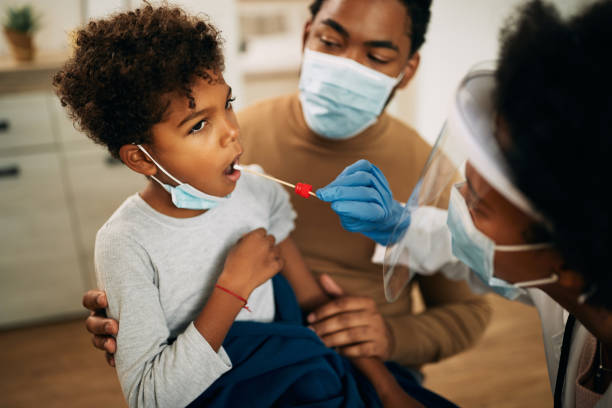 istock Small black boy having a PCR test at home during coronavirus pandemic. 1287925001