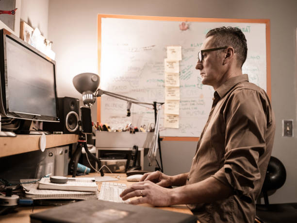 istock Male video editor working at home 1287926019