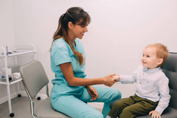 istock Friendly audiologist shaking little boys's hand in office 1287926542
