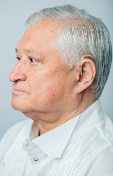 istock portrait aged man with hearing aid on the ear, close-up 1287926561