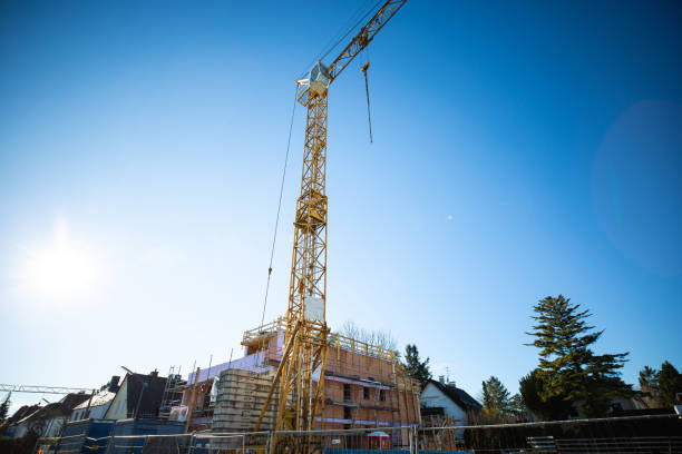 istock Structural work of a residential building with crane, blue sky 1287926613