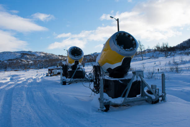 istock Snow Making Machine With Cabins in back ground. Snow Cannons lined Up on the Trail 1287930541