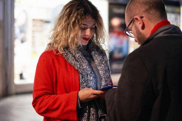 istock After their successful date, couple exchanging a mobile number so they can stay in touch 1287930994
