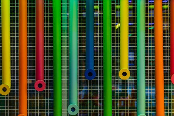 istock Colorful plastic pipes hanged on metal net 1287932392