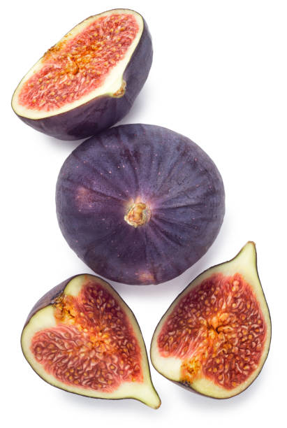 istock Whole and sliced figs with leaves isolated on white 1287936954