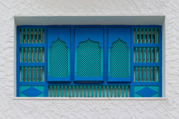 istock Tunisian turquoise slatted wooden shutters on windows at plastered wall 1287939477