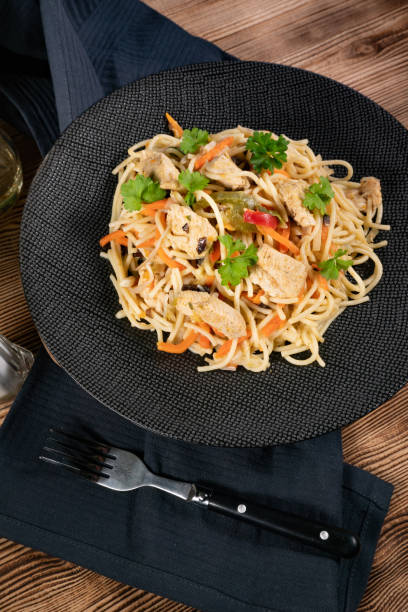 istock Fried noodles with chicken and vegetables. 1287940162