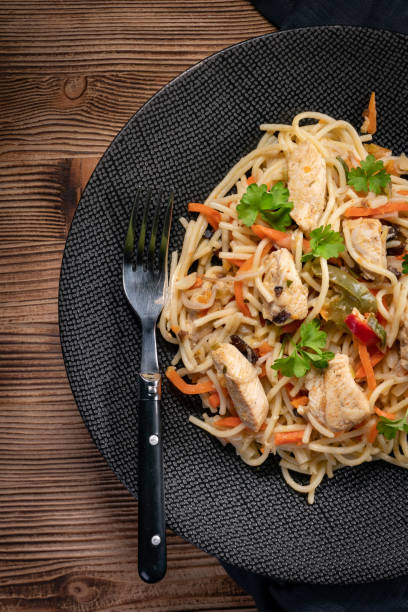 istock Fried noodles with chicken and vegetables. 1287940304