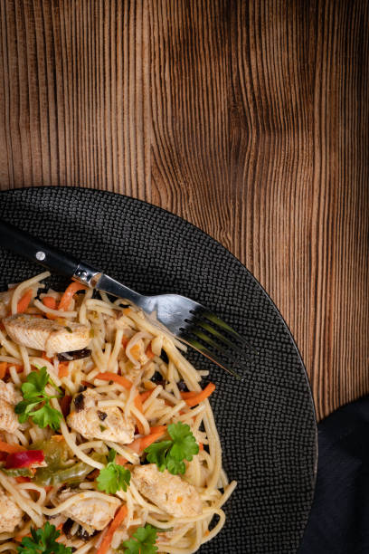 istock Fried noodles with chicken and vegetables. 1287940363