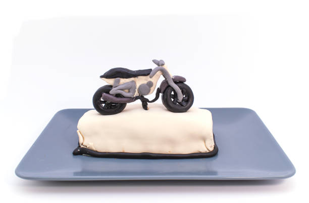 the little motorcycle-shaped cake inside the grey plate