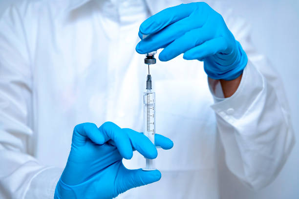 istock Medical hands with syringe for vaccination 1287941850