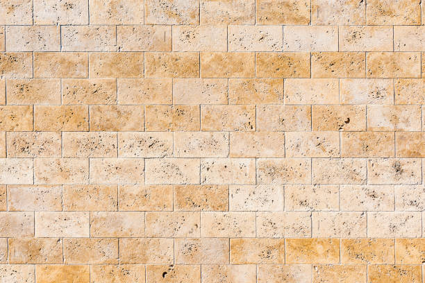 istock Yellow clean stone wall of the building. 1287942059