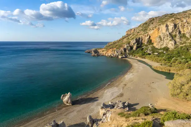 Photo of Preveli beach (aka., Palm Beach) at the mouth of the Megas river flowing through a gorgeous palm tree glade along the Kourtaliotiko gorge, Southern Crete, Greece