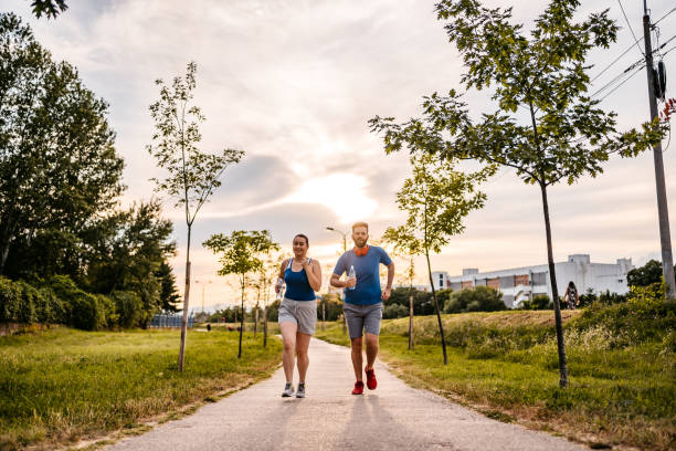 istock Young couple running together 1287943927