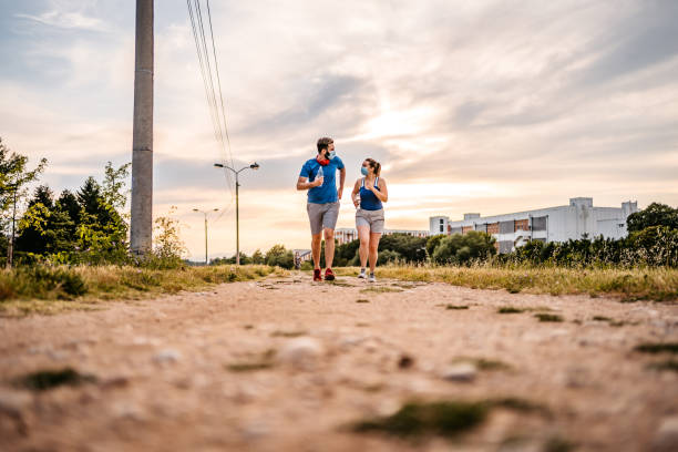 istock Young couple running together 1287944299