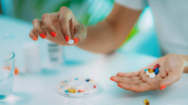 istock Female patient counting pills. Medicine non-adherence. 1287947490