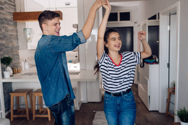 istock Happy young couple dancing at home 1287949029