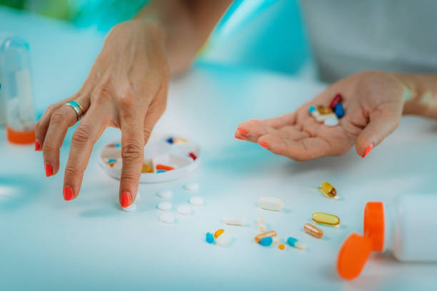 istock Female patient counting pills. Medicine non-adherence. 1287949169