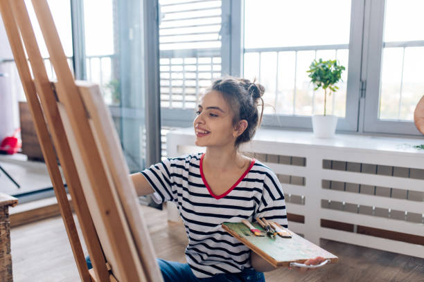 istock Young student of arts practicing painting at home 1287949977