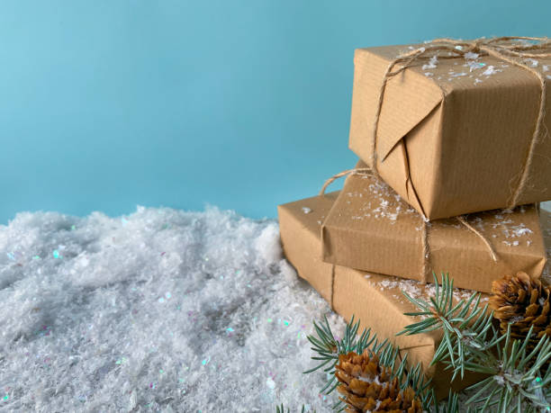 istock Winter time. Rustic gift box with craft paper. Christmas gift on snowy background. 1287952554