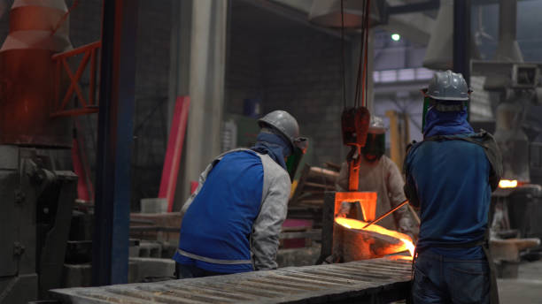 istock Metal industry work - pouring molten metal 1287953254