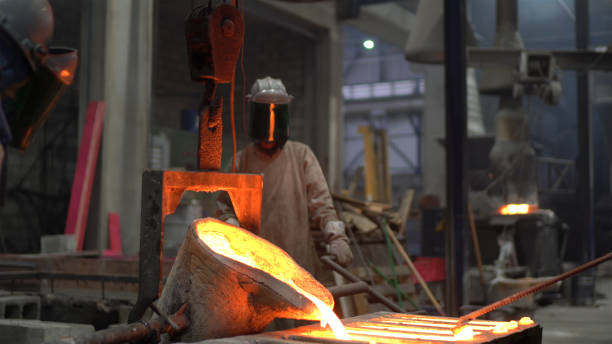 istock Metal industry work - pouring molten metal 1287953301