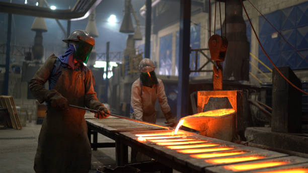 istock Metal industry work - pouring molten metal 1287953665