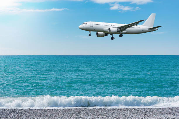 istock Flight of the plane above the ocean before landing. 1287954335