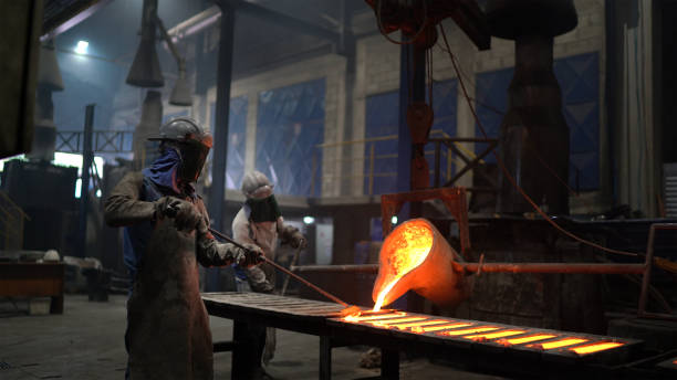 istock Metal industry work - pouring molten metal 1287954553
