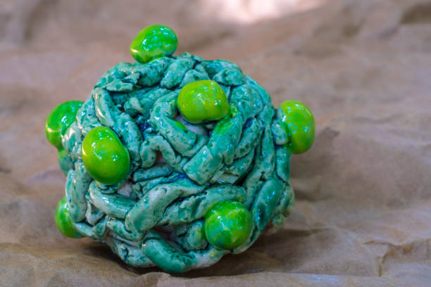 istock Clay model of Coronavirus mutation a new version coming up on the wavy background 1287956191