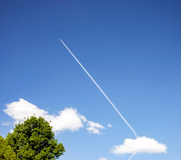 istock White contrail from the plane's turbines in the blue sky 1287957817