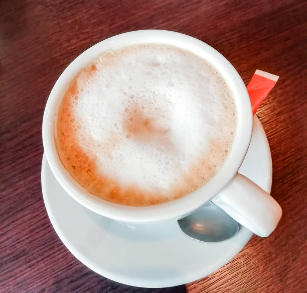 istock Foam in fresh and hot coffee with milk top view 1287957958