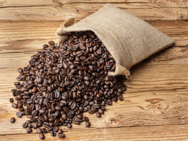 istock Coffee beans in bag on black background 1287958614