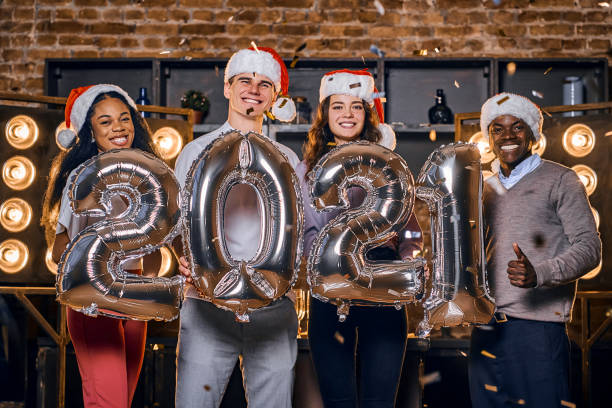istock Smiling young people celebrating New Year at home 1287958760