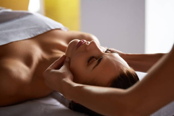 istock Head and face massage in spa salon 1287959477