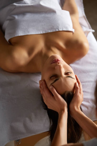 istock Head and face massage in spa salon 1287959589