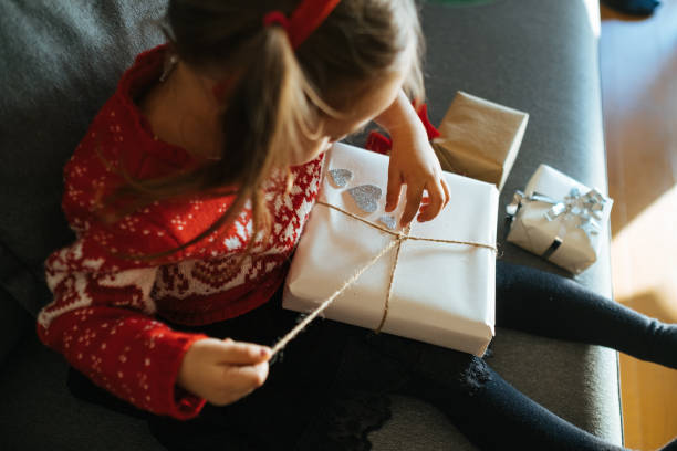 istock Happy child girl with gift 1287961000