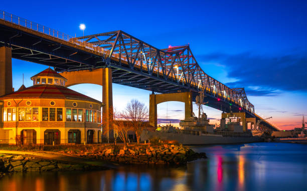 Night Landscape over Braga Bridge in Fall River Dramatic twilight sky and reflections over the Fall River at Heritage State Park in Fall River, Massachusetts. massachusetts stock pictures, royalty-free photos & images
