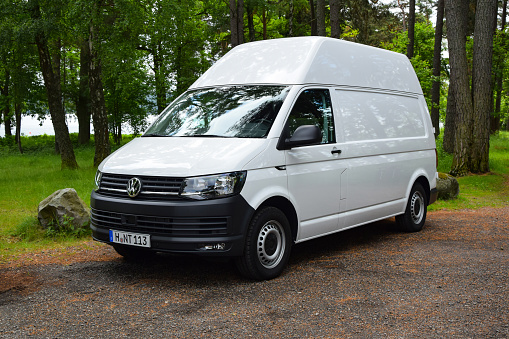 Stockholm, Sweden - 25th June, 2015: White delivery van Volkswagen Transporter stopped on a parking. This model is a popular light commercial vehicle in Europe.