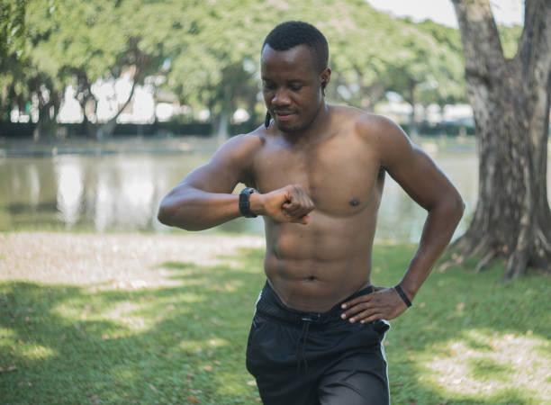 istock muscular young man exercise in green forest park 1287971665