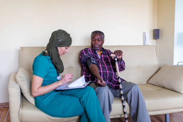 istock Home carer checking patients pulse at home 1287973105