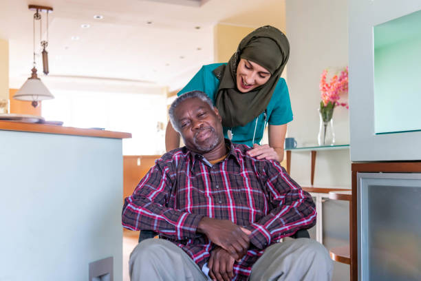 istock Professional experienced caregiver looking after her patient 1287973188