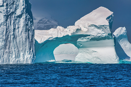 Stock photograph of an iceberg bridge, hole formation in the Antartic Peninsula, Antarctica.