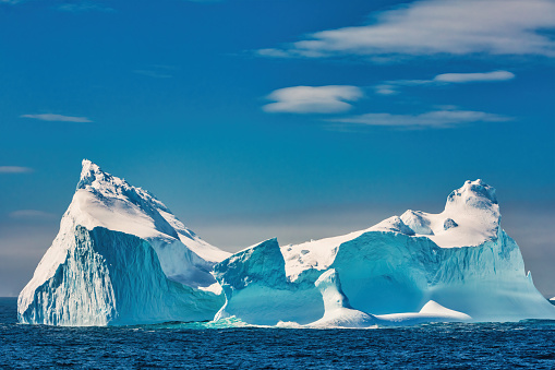 Stock photograph of an iceberg in Antarctica on a sunny day.