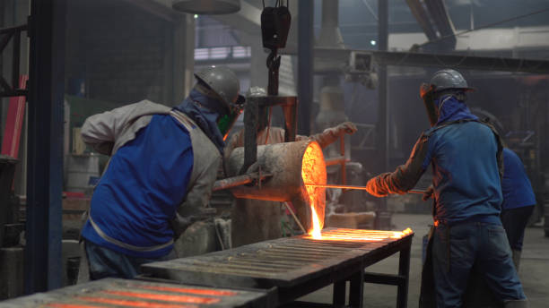istock Metal industry work - pouring molten metal 1287985864