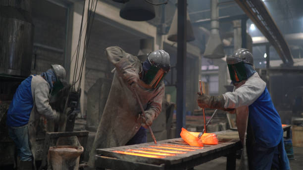 istock Metal industry work - pouring molten metal 1287985998