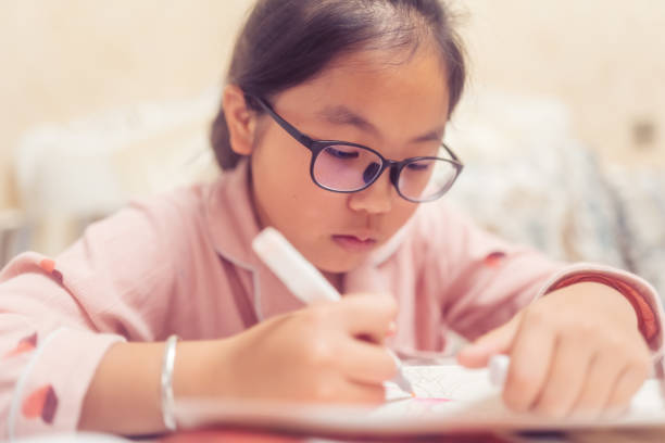 istock little girl is doing homework 1287993438