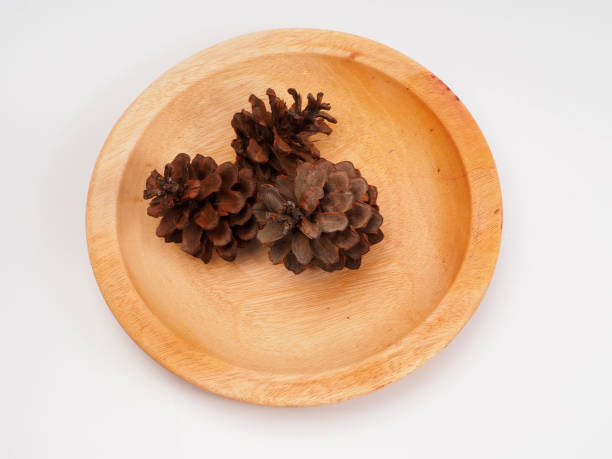 istock Group of pine cone on a wooden plate 1287996623